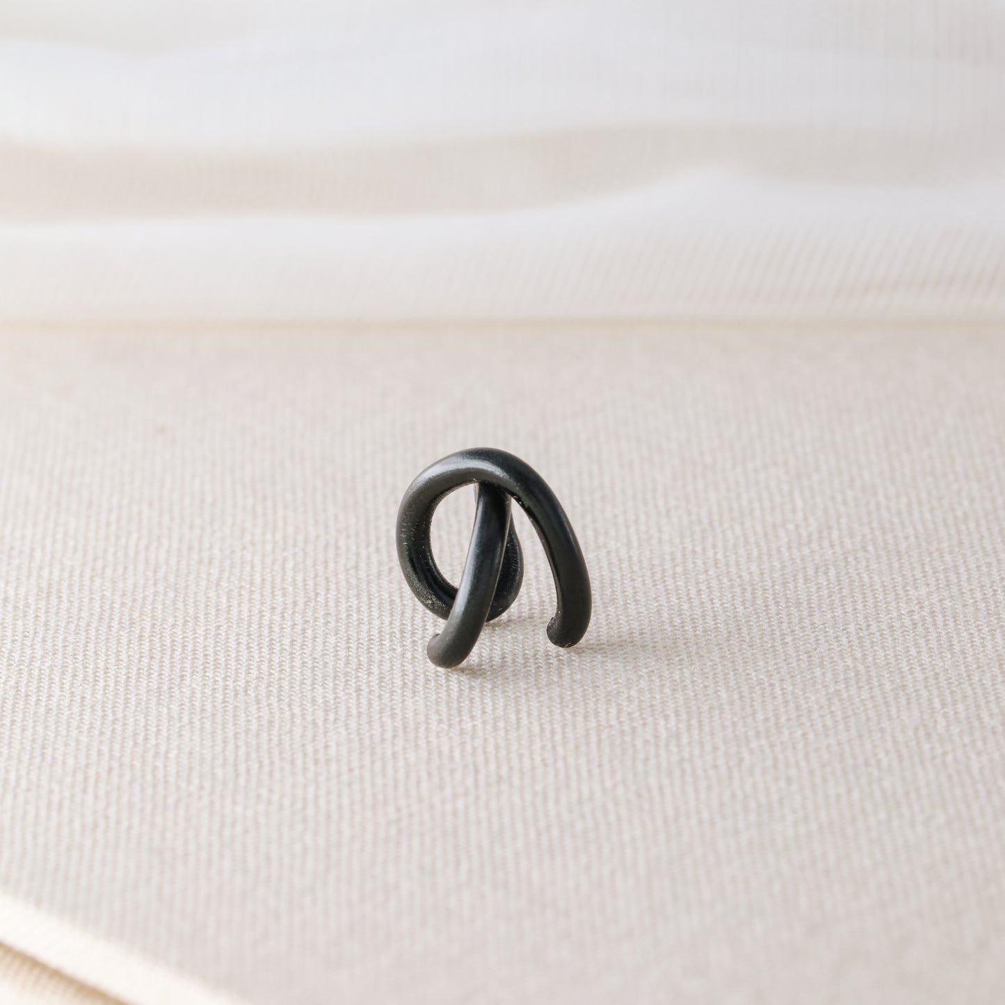 Adjustable no-piercing helix ear cuff shown worn on the upper cartilage area, available in silver, black and soft gold with Double Line and Criss-Cross style options for a bold stacked ear look.
