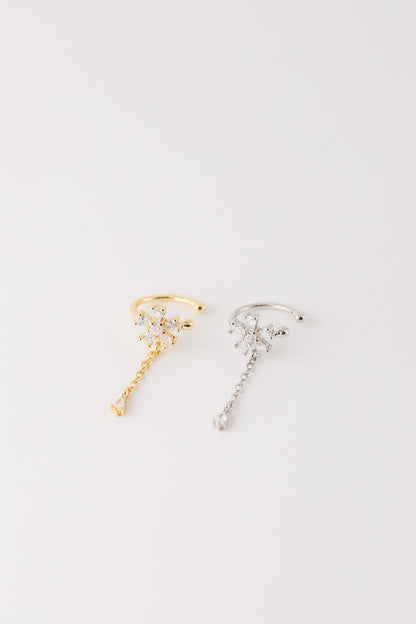 Sparkling flower ear cuff with dainty drop chain in 18k gold plated sterling silver and 925 silver, worn on cartilage without piercing.