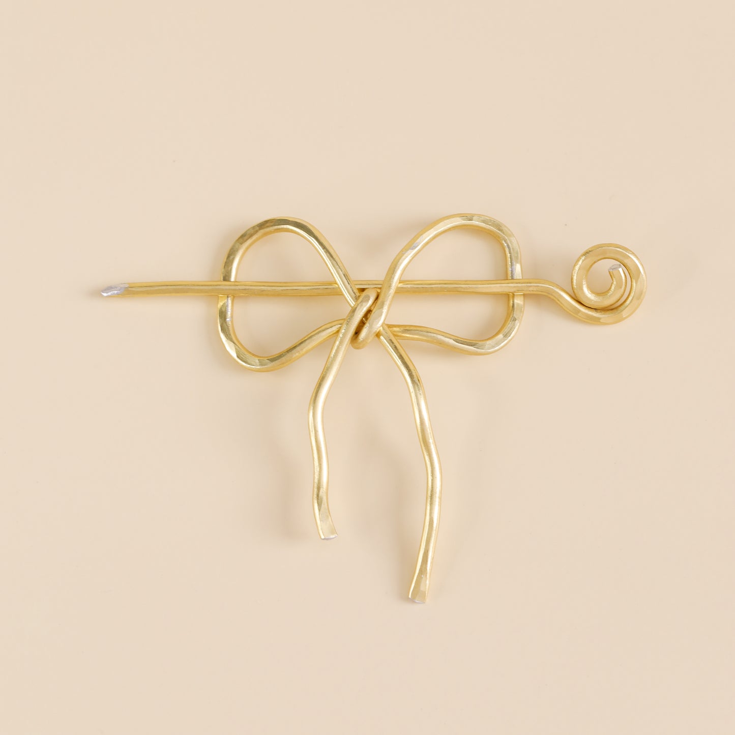 Handmade aluminum bow shawl pin brooch with matching removable stick pin, shown in gold and available in silver or gold finish, designed as a decorative and functional scarf fastener for shawls, sweaters, cardigans, knit wraps and crochet pieces, with a romantic bow shape and minimalist metal design.