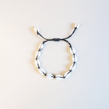 Adjustable cowrie shell anklet with black cotton cord and natural white shells