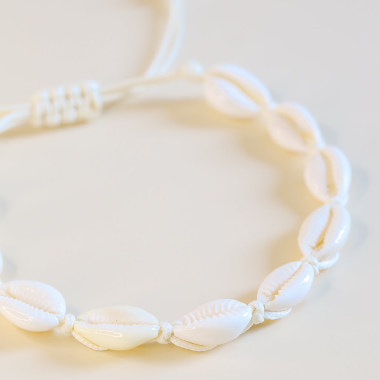 Cowrie shell anklet with cotton cord styled for beach and summer outfits