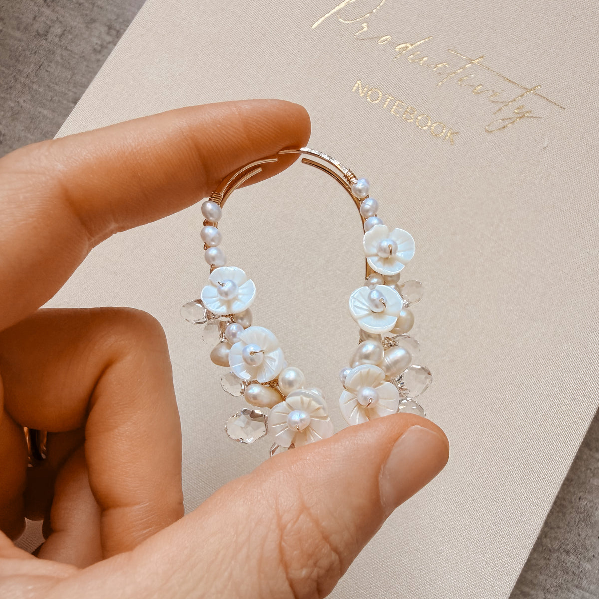 Handmade pair of 50 mm bridal ear climbers featuring genuine freshwater pearls, white mother-of-pearl flowers and faceted clear briolette crystal drops arranged along curved metal ear climber wires.