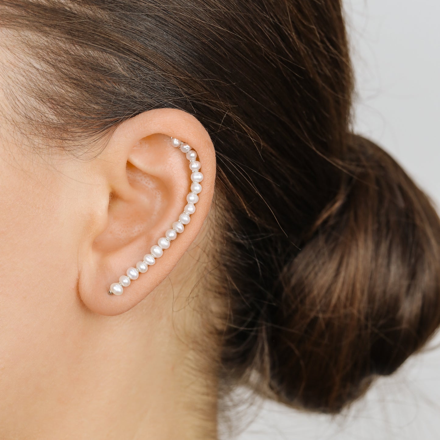 Handmade 50 mm pearl ear climber earrings worn along the natural curve of the ear, featuring tiny 2–3 mm pearls arranged in a delicate climbing design for one standard lobe piercing, available as a pair, single left ear climber or single right ear climber in solid 925 sterling silver, 14k gold filled and 14k rose gold filled, with ear climber lengths available from 10mm to 50mm.