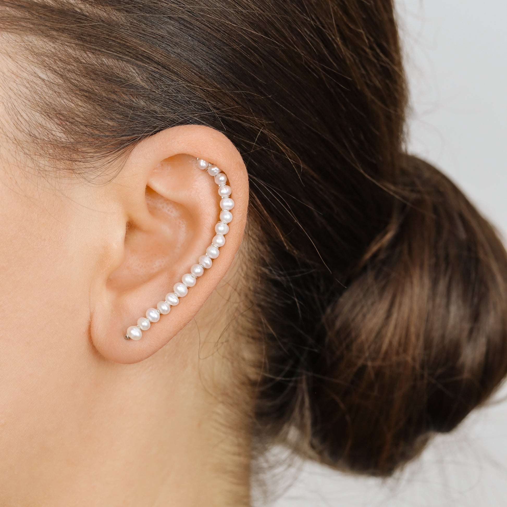 Handmade 50 mm pearl ear climber earrings worn along the natural curve of the ear, featuring tiny 2–3 mm pearls arranged in a delicate climbing design for one standard lobe piercing, available as a pair, single left ear climber or single right ear climber in solid 925 sterling silver, 14k gold filled and 14k rose gold filled, with ear climber lengths available from 10mm to 50mm.
