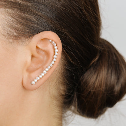Handmade 50 mm pearl ear climber earrings worn along the natural curve of the ear, featuring tiny 2–3 mm pearls arranged in a delicate climbing design for one standard lobe piercing, available as a pair, single left ear climber or single right ear climber in solid 925 sterling silver, 14k gold filled and 14k rose gold filled, with ear climber lengths available from 10mm to 50mm.