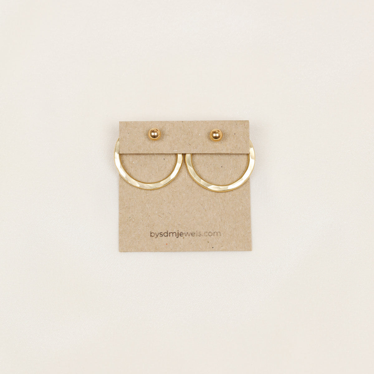 Pair of gold hammered round ear jackets displayed with matching ball studs, showing the coordinated two-ear configuration and interchangeable stud design.