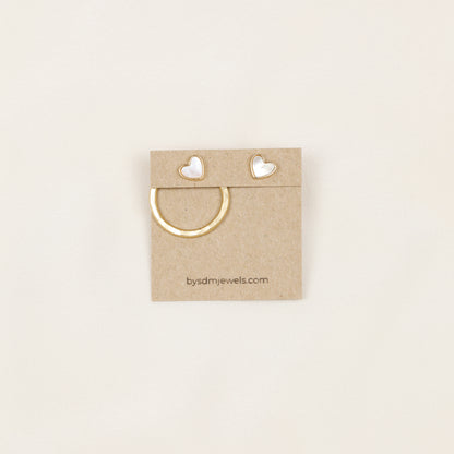 Gold round ear jacket displayed with a white heart stud, showing how the removable circular jacket can be combined with different stud earrings.
