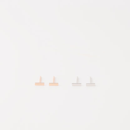 Tiny rectangle bar stud earrings in solid 925 sterling silver on white background