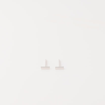 Tiny rectangle bar stud earrings in solid 925 sterling silver on white background