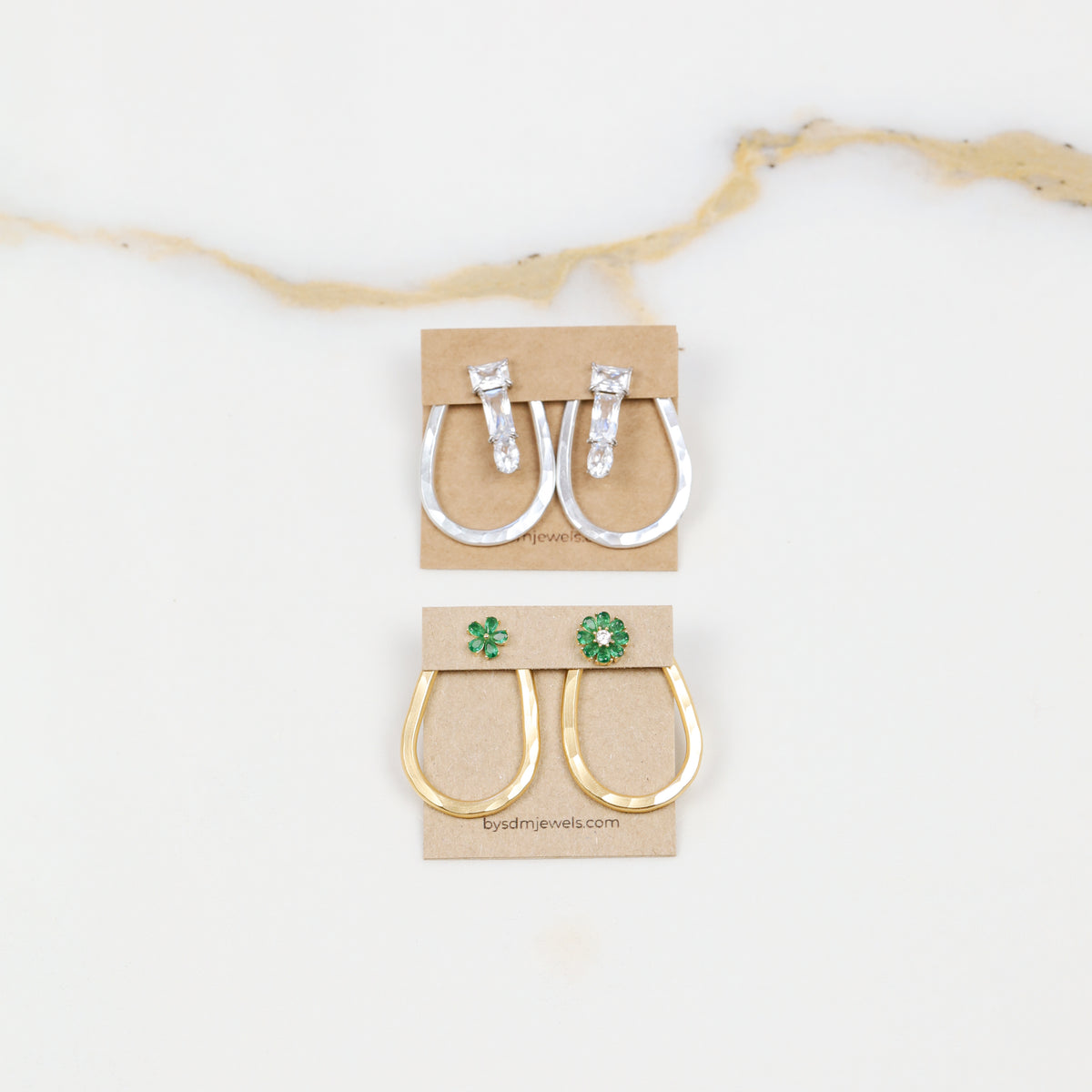 Selection of gold and silver teardrop ear jacket backs displayed with different stud styles to illustrate possible styling combinations.