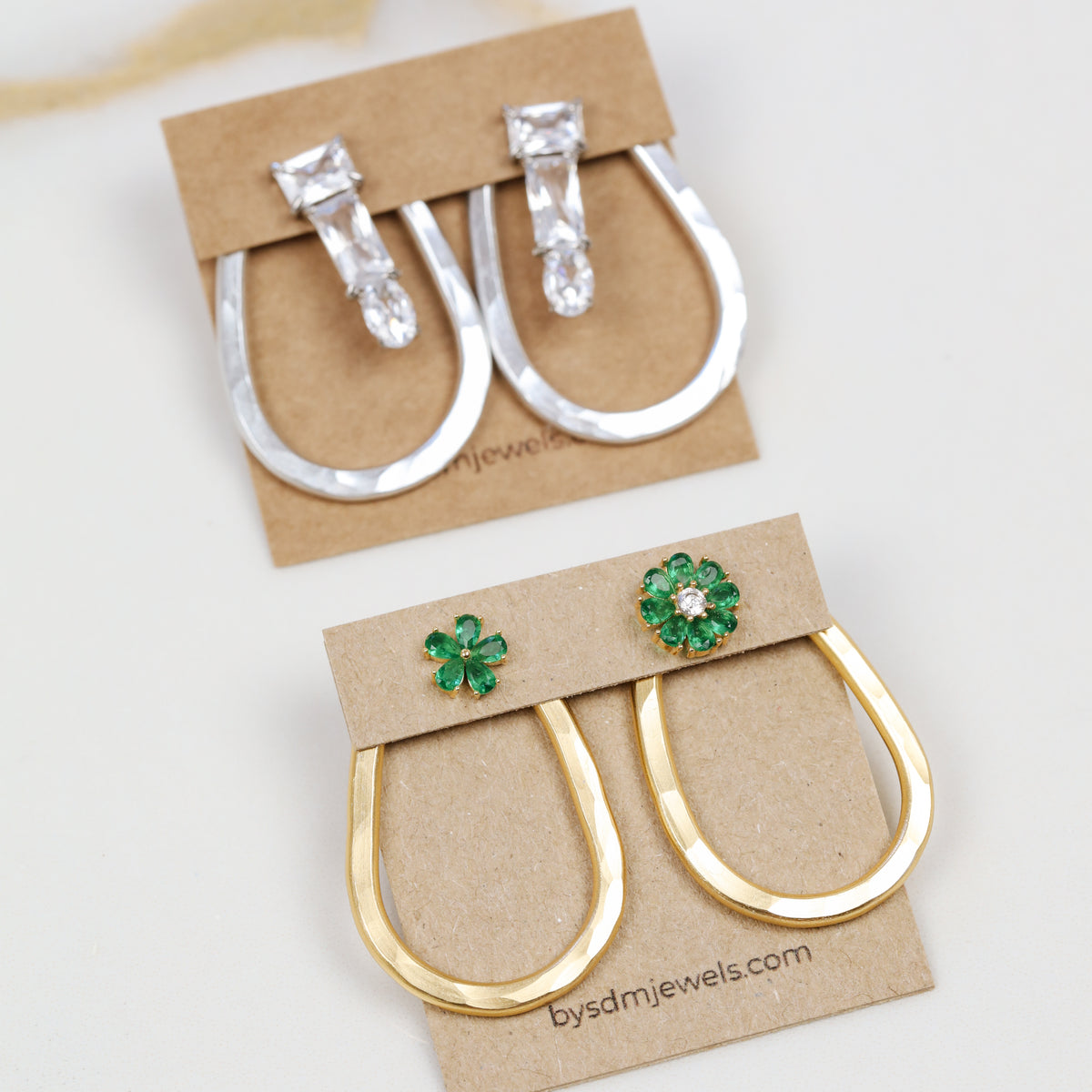 Selection of gold and silver teardrop ear jacket backs displayed with different stud styles to illustrate possible styling combinations.