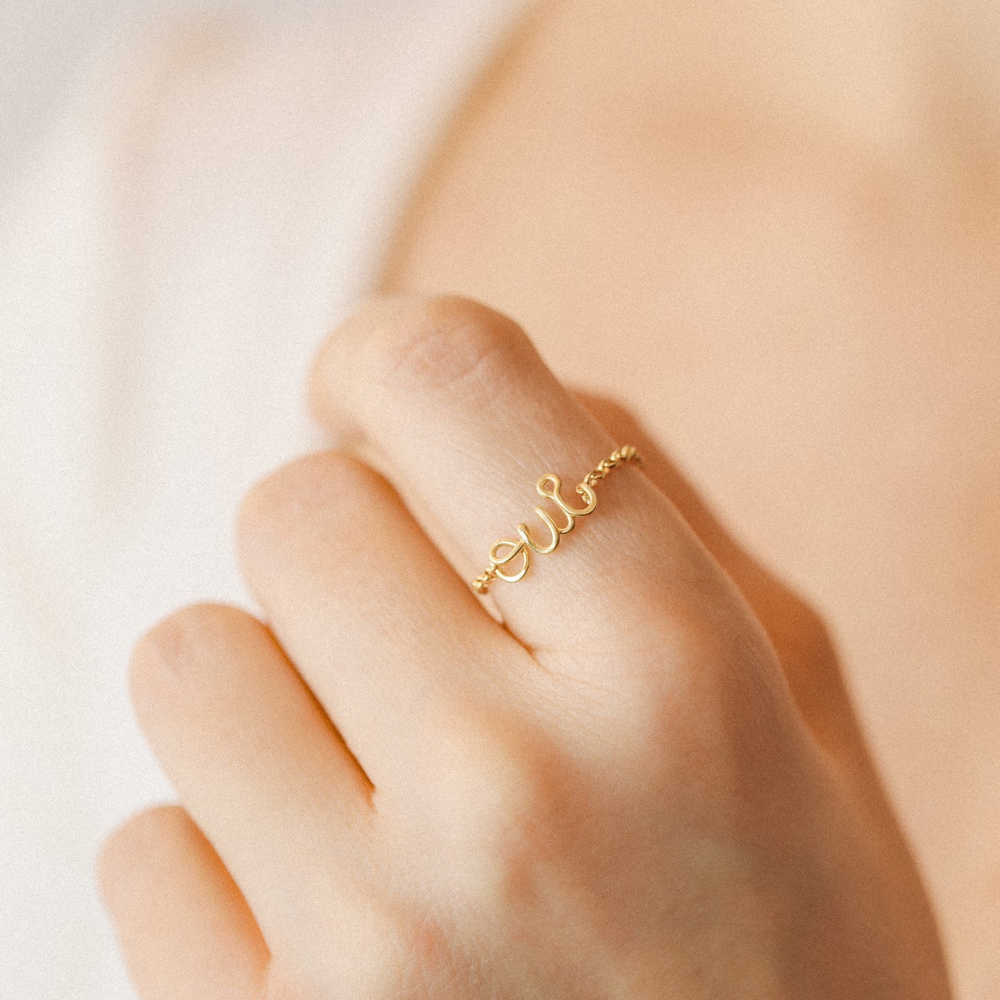 Personalized gold name chain ring worn on finger