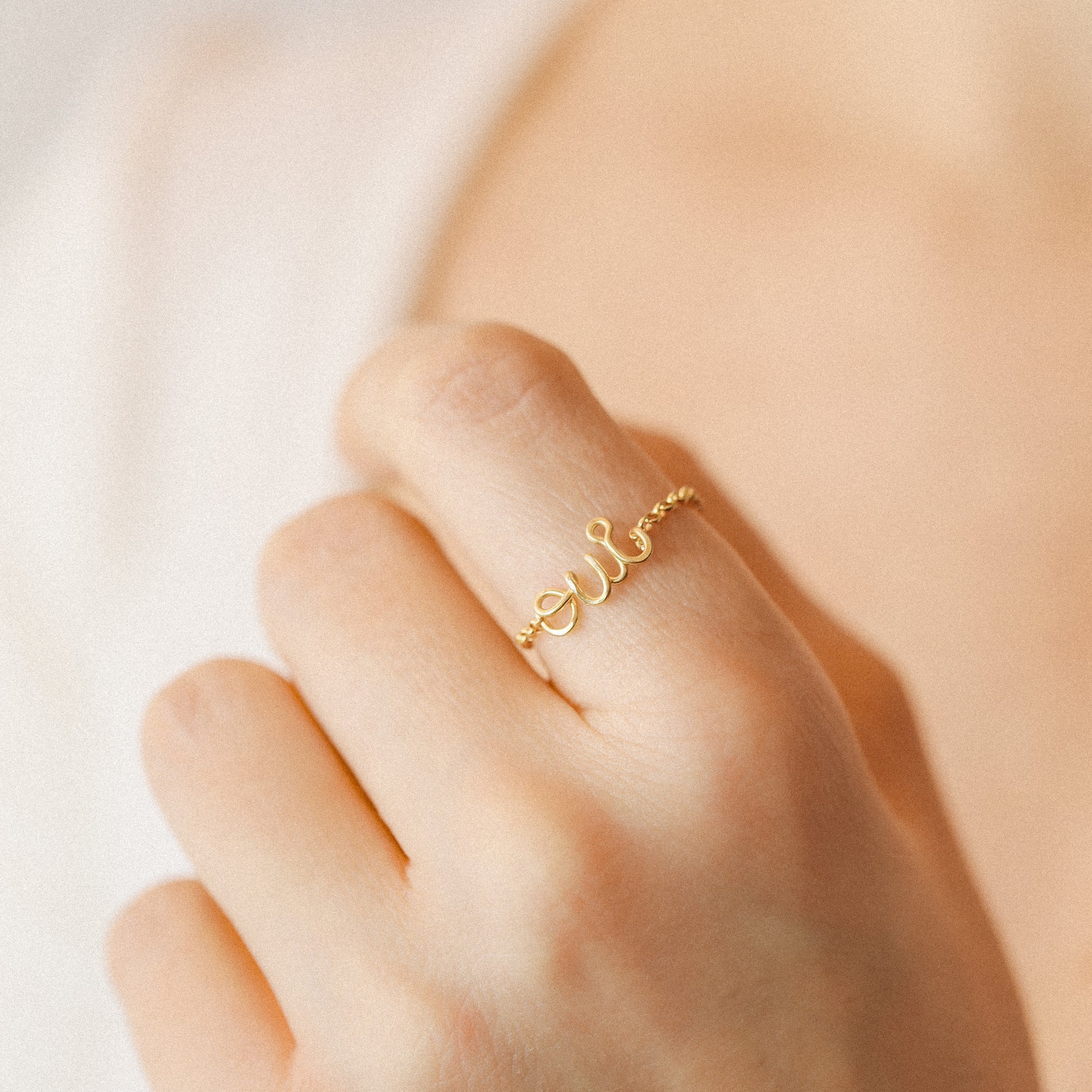 Personalized gold name chain ring worn on finger