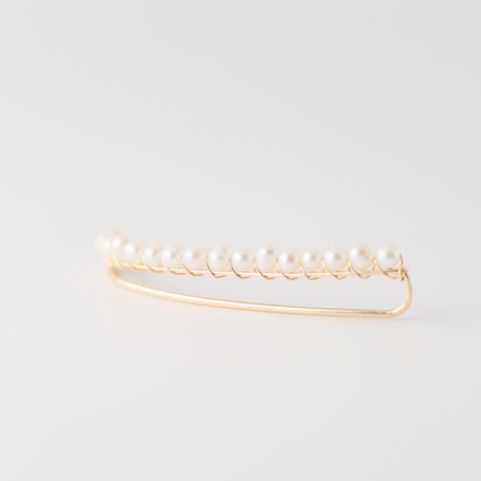 Handmade 50 mm pearl ear climber earrings worn along the natural curve of the ear, featuring tiny 2–3 mm pearls arranged in a delicate climbing design for one standard lobe piercing, available as a pair, single left ear climber or single right ear climber in solid 925 sterling silver, 14k gold filled and 14k rose gold filled, with ear climber lengths available from 10mm to 50mm.