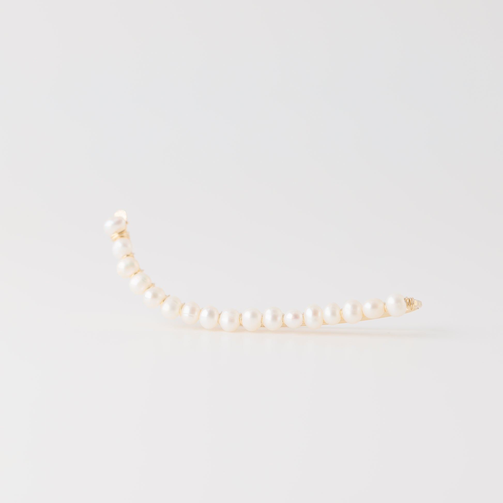 Handmade 50 mm pearl ear climber earrings worn along the natural curve of the ear, featuring tiny 2–3 mm pearls arranged in a delicate climbing design for one standard lobe piercing, available as a pair, single left ear climber or single right ear climber in solid 925 sterling silver, 14k gold filled and 14k rose gold filled, with ear climber lengths available from 10mm to 50mm.