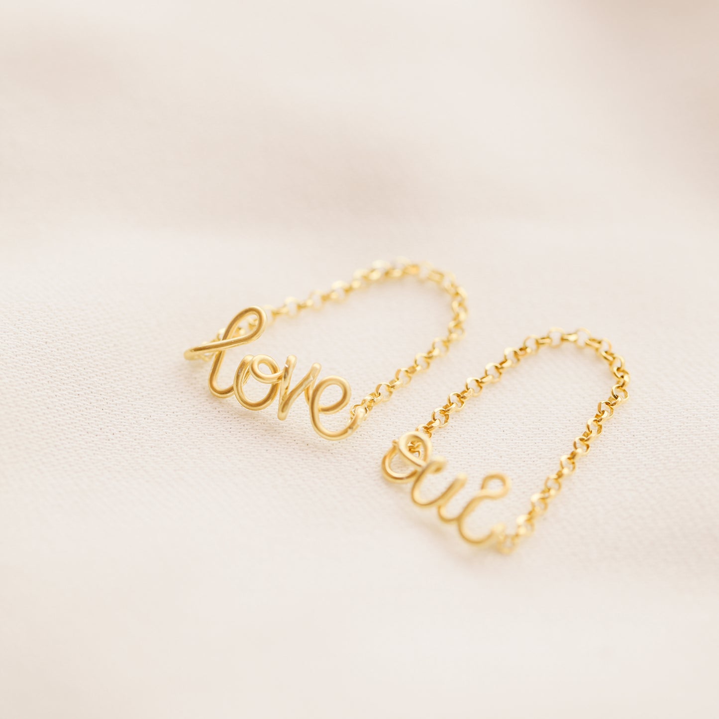 Gold personalized chain ring on neutral background