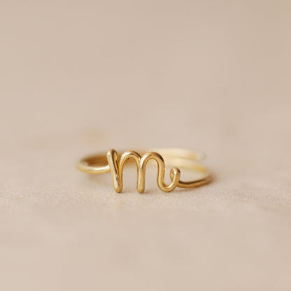 Handmade 14k gold filled wire ring shaped into the letter M.