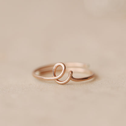 Handmade 14k rose gold filled wire ring shaped into the letter E.