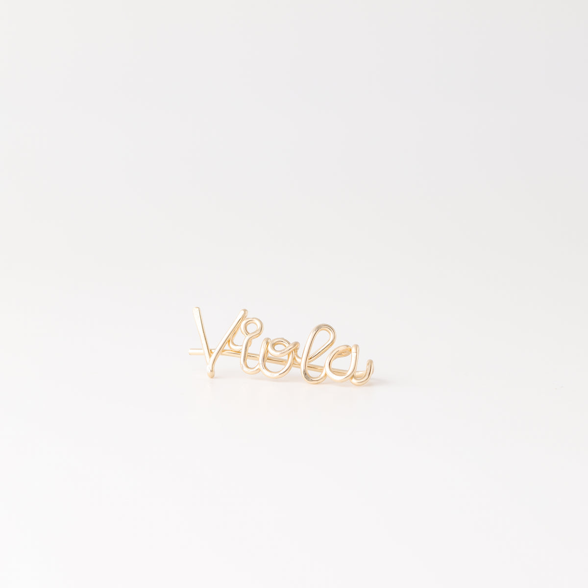 Handmade personalized name ear climber worn across the lobe through one standard piercing, featuring a custom flowing wire script design made with the chosen name or word up to 10 characters, available as a single left ear climber, single right ear climber or pair in solid 925 sterling silver, 14k gold filled and 14k rose gold filled.