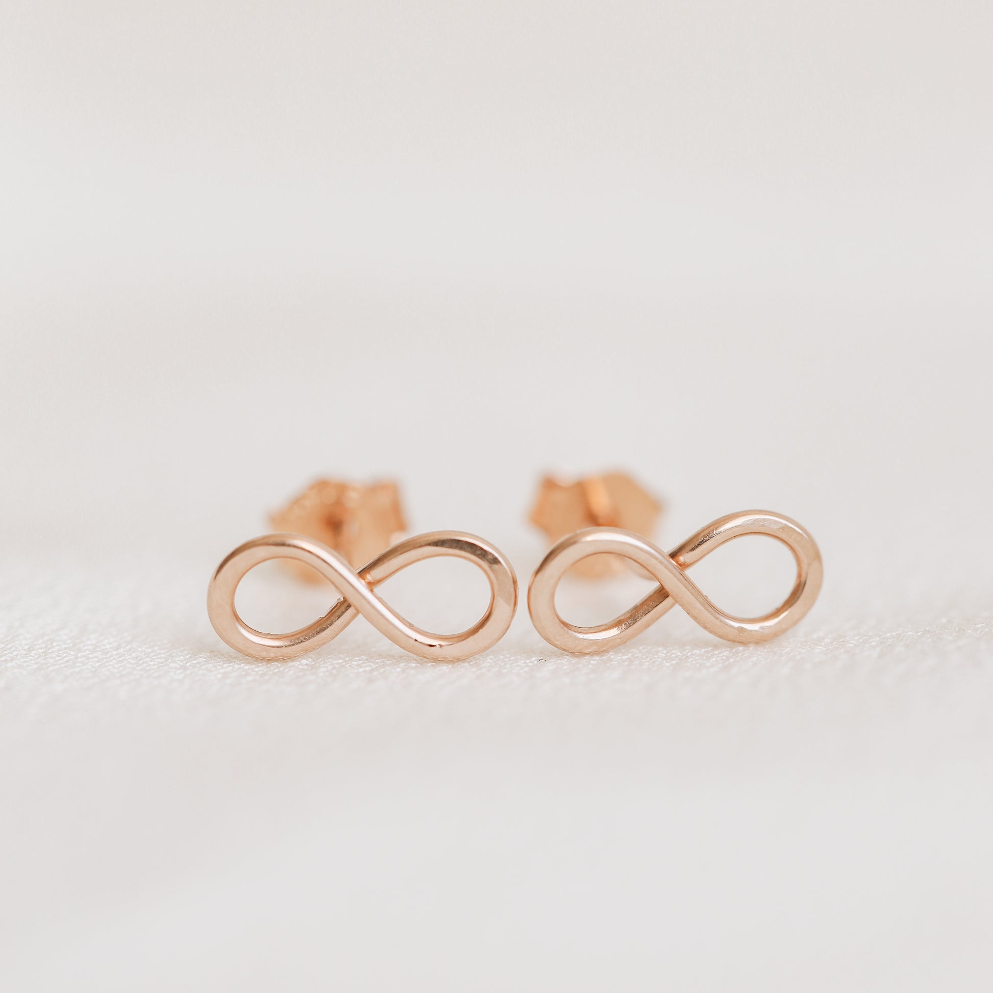 Rose gold infinity knot stud earrings dainty minimalist jewelry