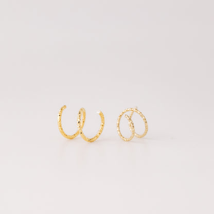 Minimal gold double hoop earrings with spiral twist design worn on ear, illusion of double piercing, diamond cut sterling silver jewelry