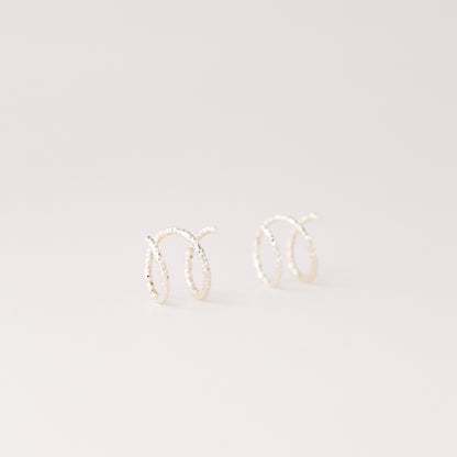 Minimal silver double hoop earrings on ear, tiny spiral earrings, sterling silver illusion double piercing jewelry