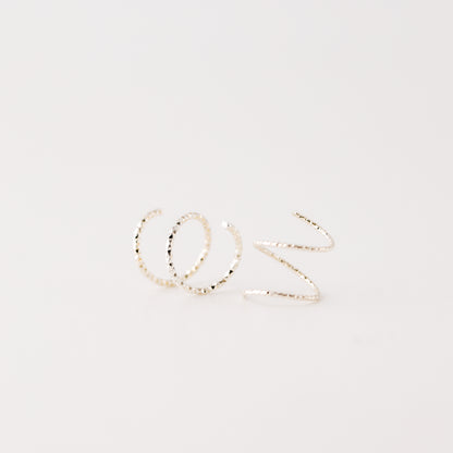 Minimal silver double hoop earrings on ear, tiny spiral earrings, sterling silver illusion double piercing jewelry