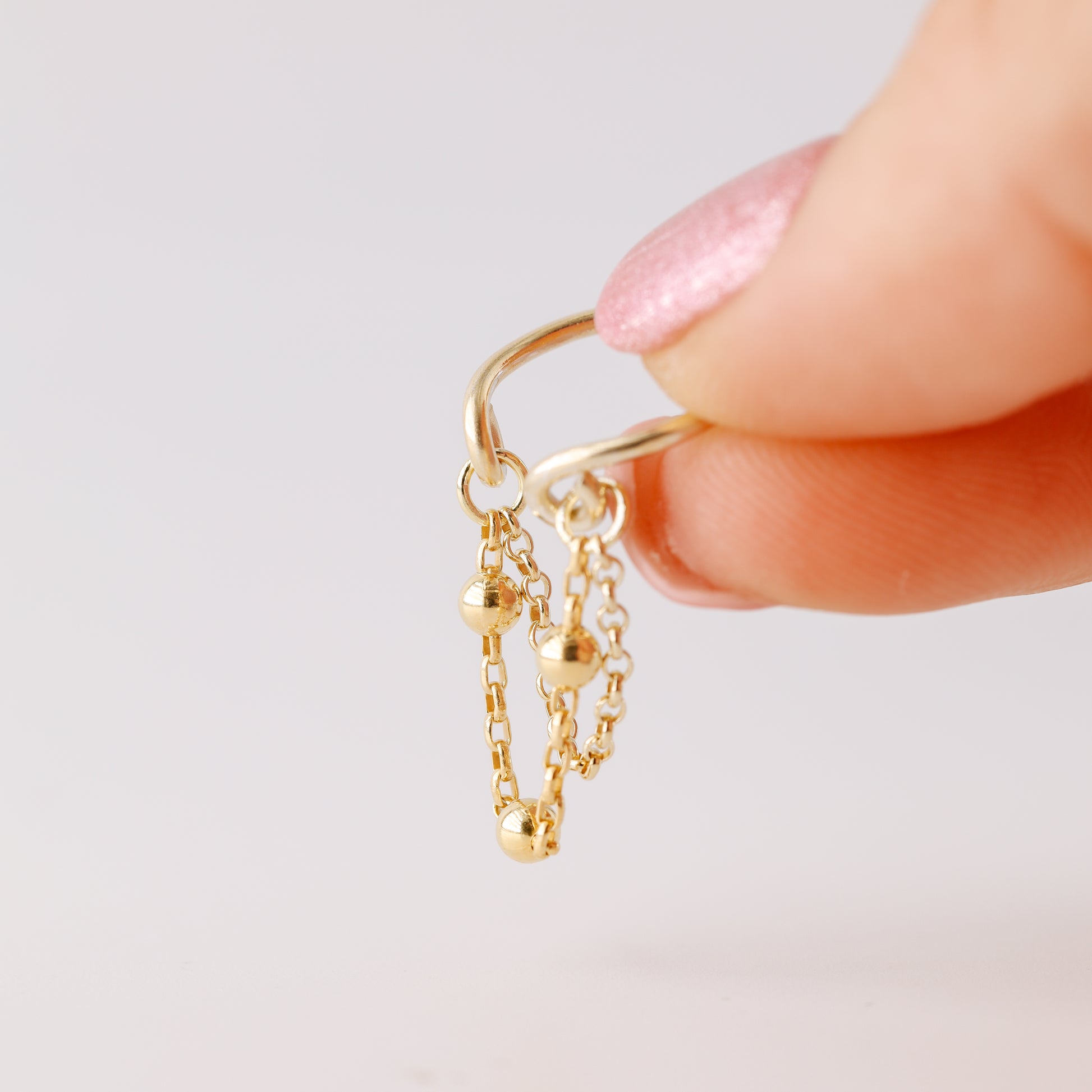 Gold beaded chain ear cuff worn on the conch with double draped chain detail