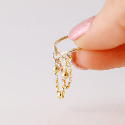 Gold beaded chain ear cuff worn on the conch with double draped chain detail