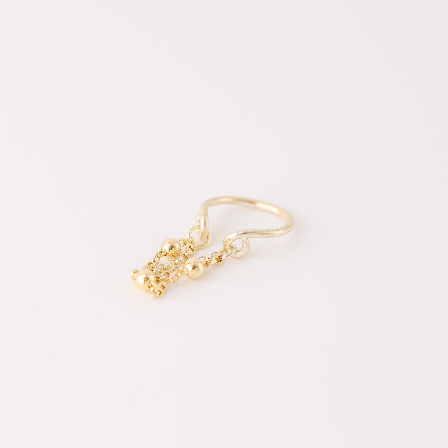 Gold beaded chain ear cuff worn on the conch with double draped chain detail