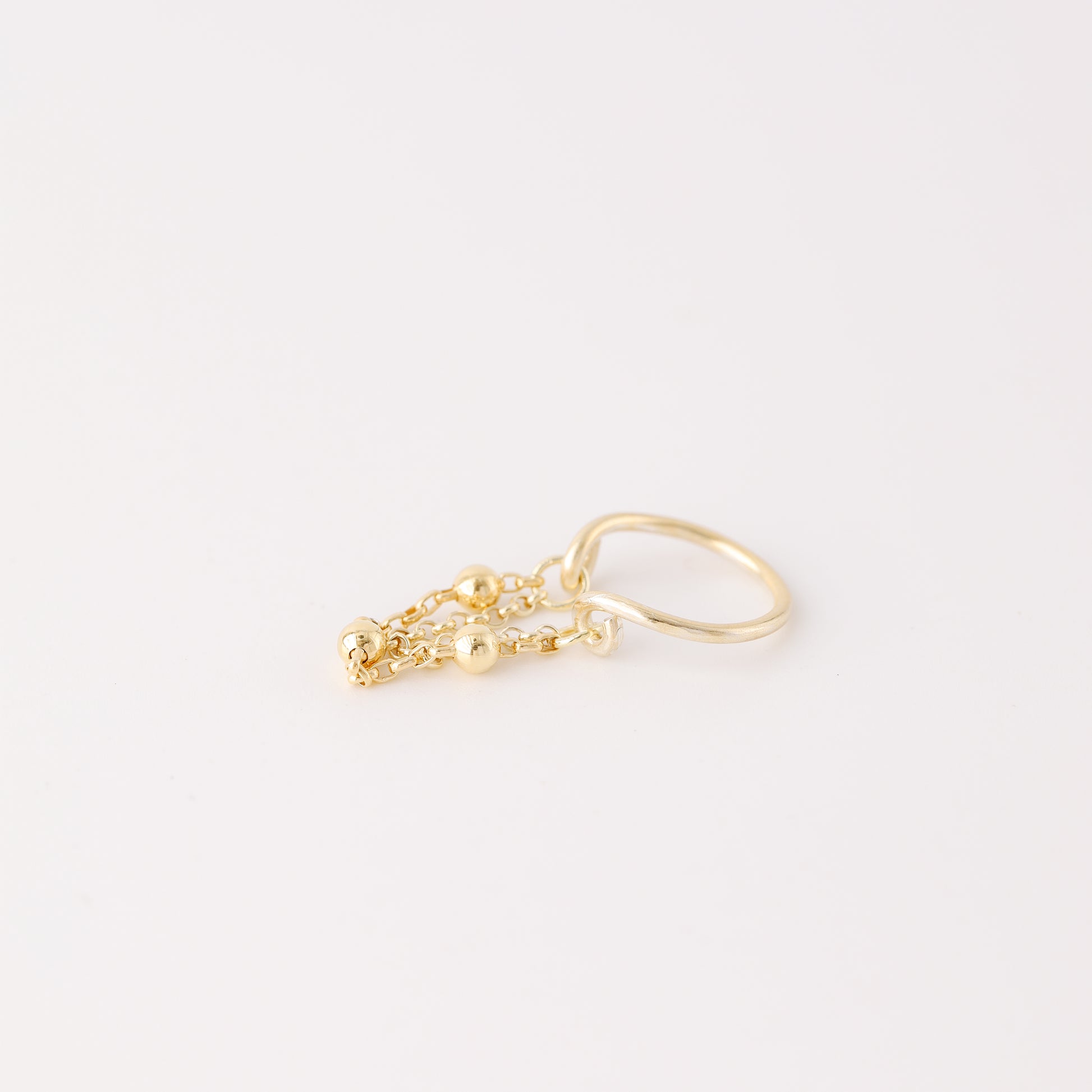 Gold beaded chain ear cuff worn on the conch with double draped chain detail
