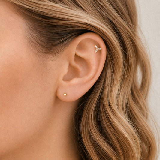Minimal marquise cartilage stud earring in gold worn on helix piercing