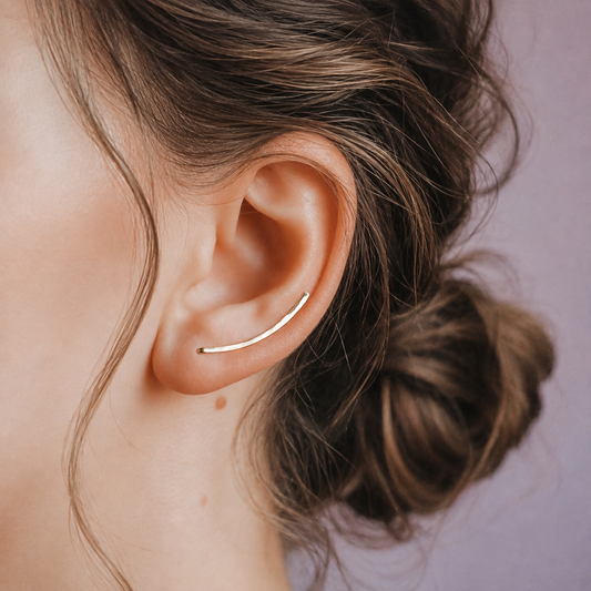 Handmade 25 mm minimalist ear climber earrings worn through one standard lobe piercing and rotated upward along the natural curve of the ear, featuring a delicate medium-short hand hammered wire design with a dainty ear sweep shape, available as a single left ear climber, single right ear climber or pair in solid 925 sterling silver, 14k gold filled and 14k rose gold filled, with length options from 10mm to 50mm.