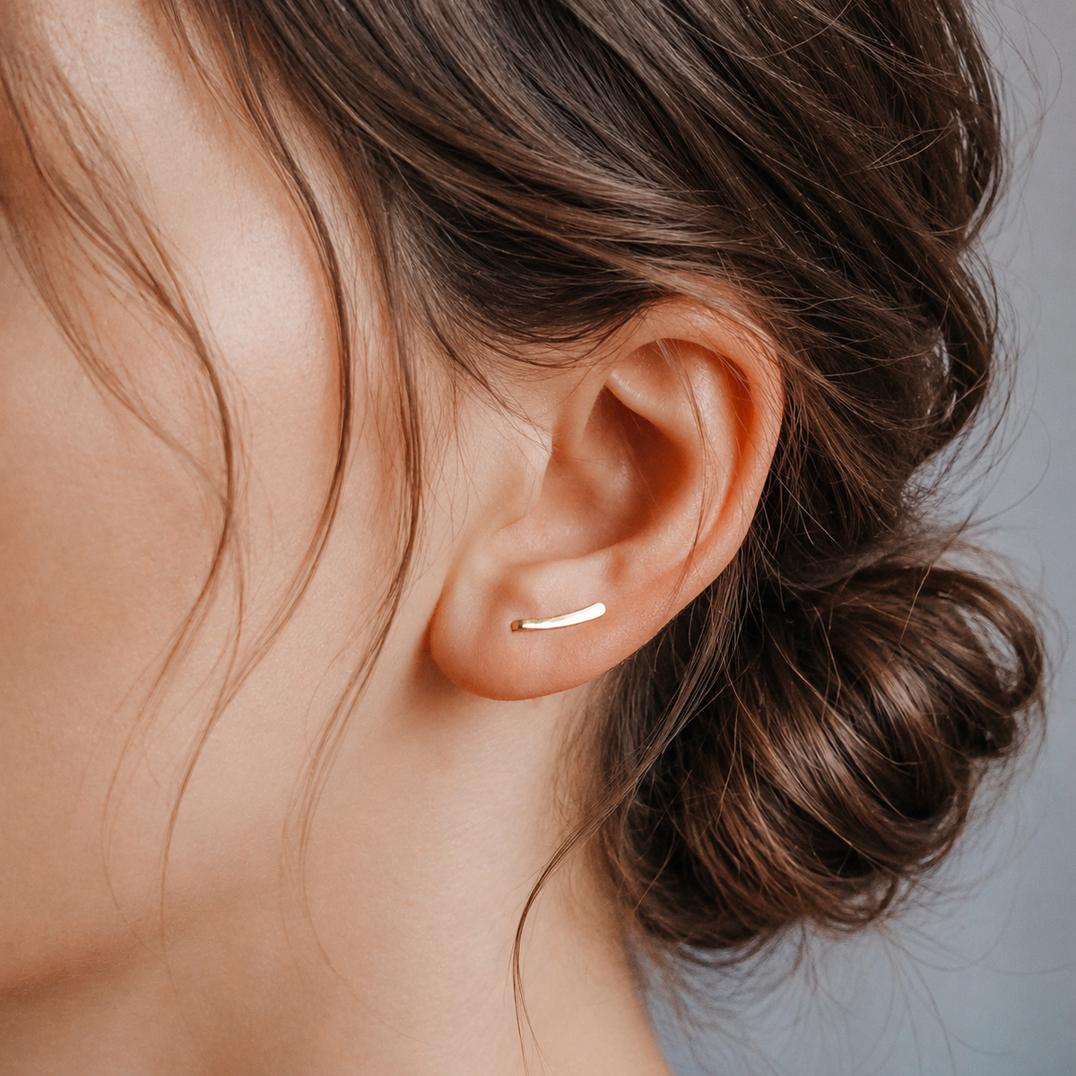 Handmade 10 mm minimalist ear climber earrings worn through one standard lobe piercing and rotated upward along the natural curve of the ear, featuring a tiny hand hammered wire design with a short discreet ear sweep shape, available as a single left ear climber, single right ear climber or pair in solid 925 sterling silver, 14k gold filled and 14k rose gold filled, with length options from 10mm to 50mm.