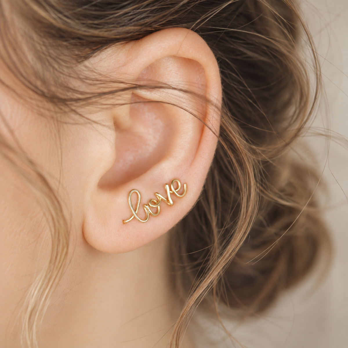 Handmade personalized name ear climber worn across the lobe through one standard piercing, featuring a custom flowing wire script design made with the chosen name or word up to 10 characters, available as a single left ear climber, single right ear climber or pair in solid 925 sterling silver, 14k gold filled and 14k rose gold filled.