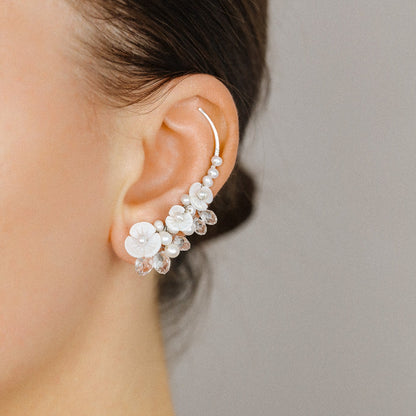 Side view of bridal floral ear climbers styled with pearls and sparkling crystal drops