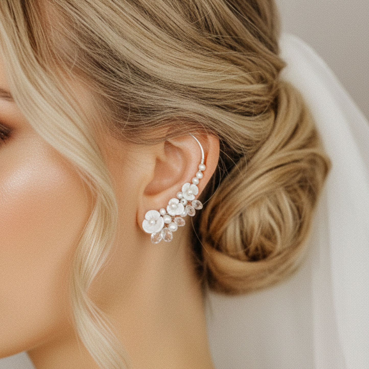 Side view of bridal floral ear climbers styled with pearls and sparkling crystal drops