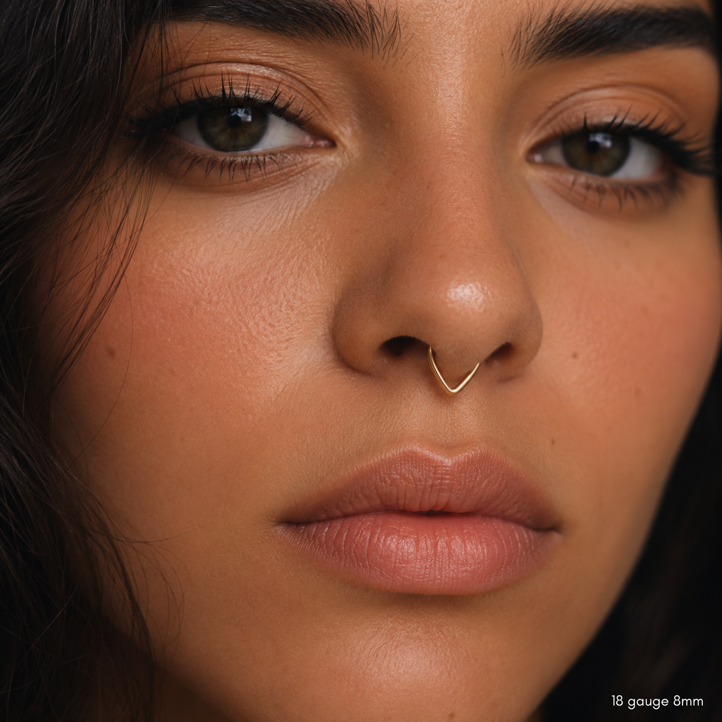 Close-up of a V-shaped chevron septum hoop showing the thin round wire and open design.