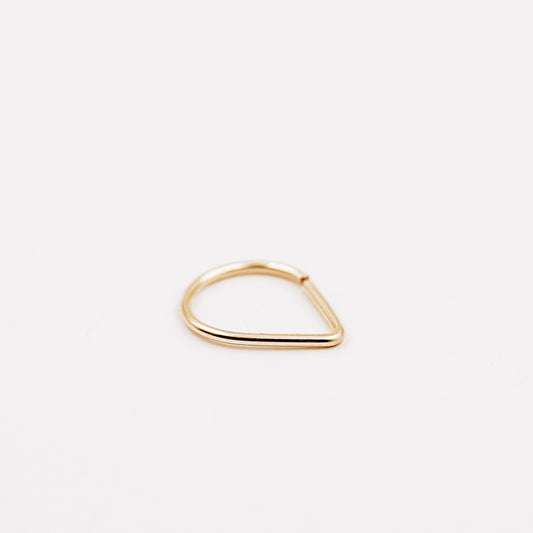 Gold filled chevron septum ring with open hoop design on a clean white background.