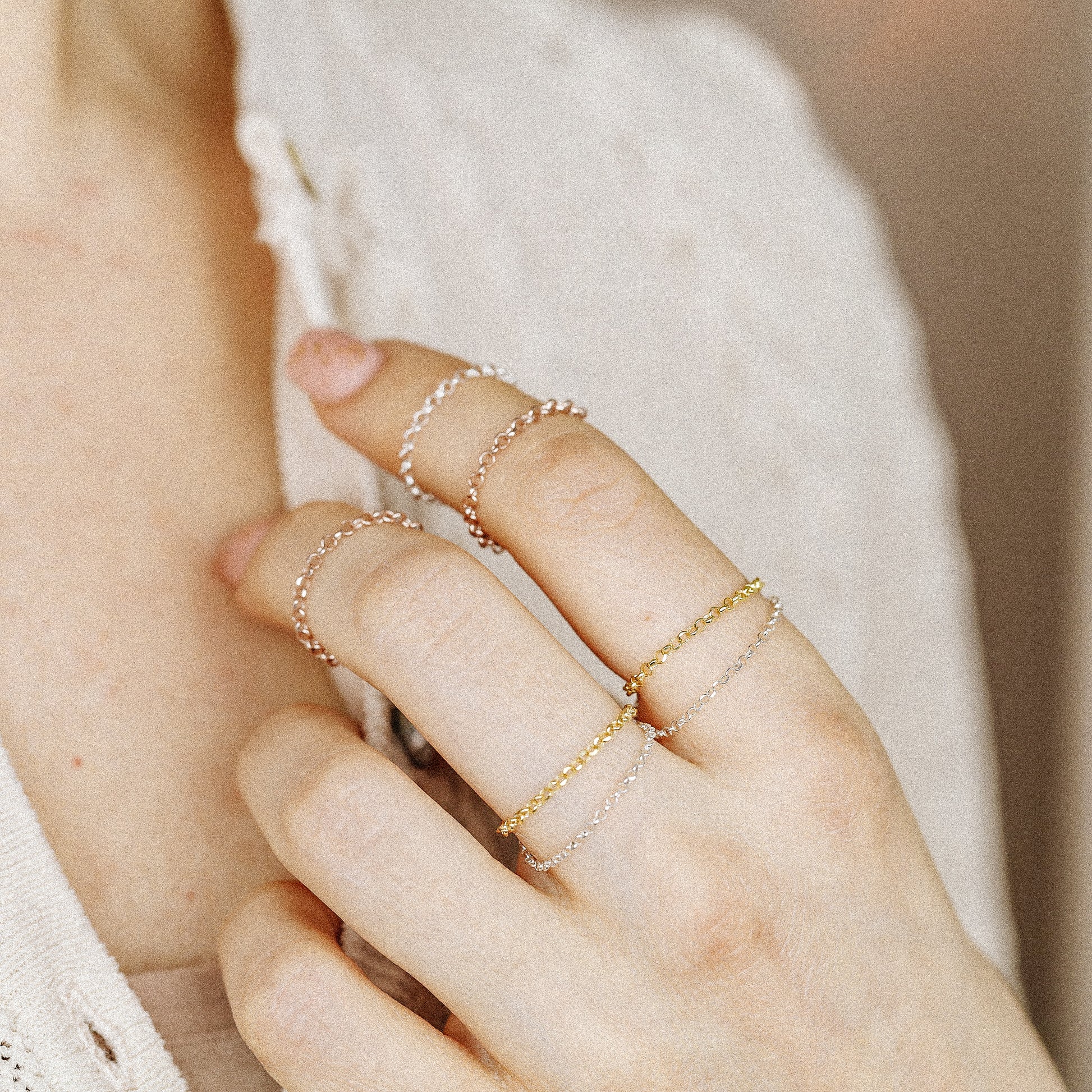 Minimal chain rings worn as delicate stacking jewelry