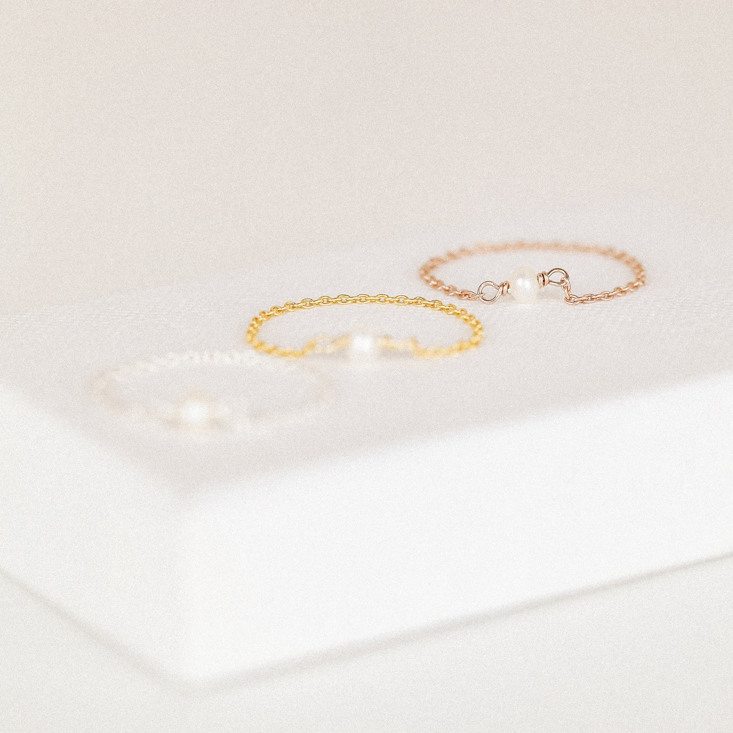 Freshwater pearl chain ring in silver gold and rose gold finishes displayed on soft white background