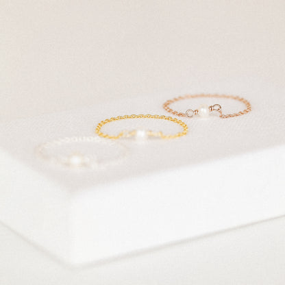 Freshwater pearl chain ring in silver gold and rose gold finishes displayed on soft white background