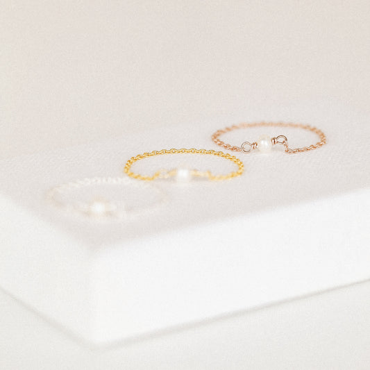 Freshwater pearl chain ring in silver gold and rose gold finishes displayed on soft white background