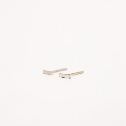 Tiny rectangle bar stud earrings in solid 925 sterling silver on white background