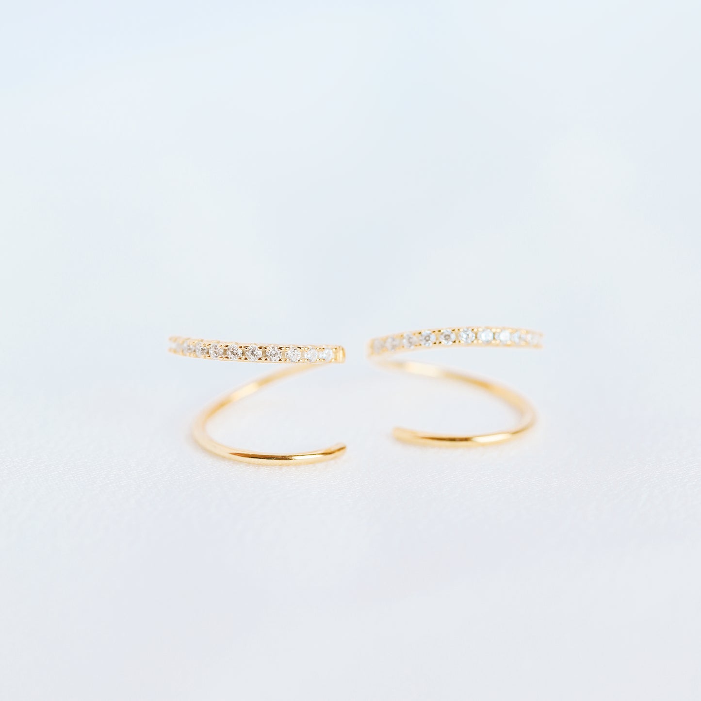 Lightweight gold twist hoop earring worn on ear