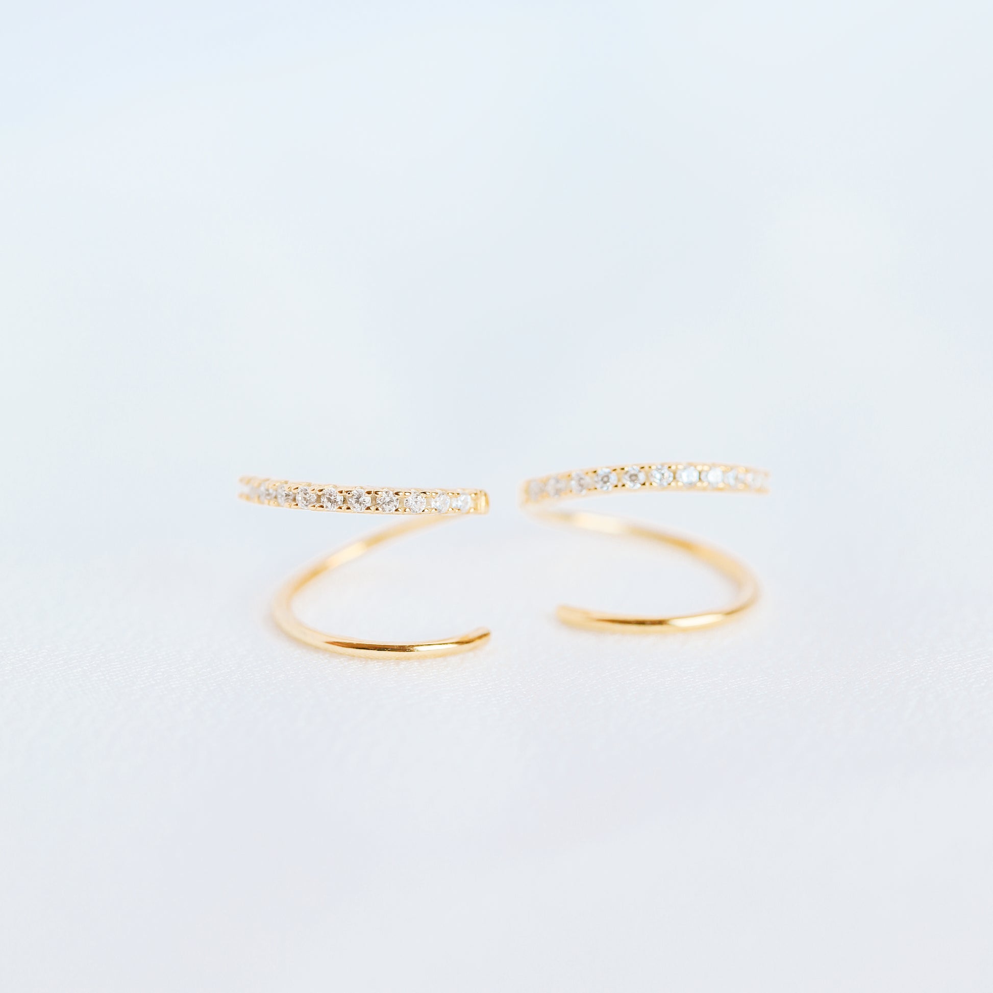 Lightweight gold twist hoop earring worn on ear