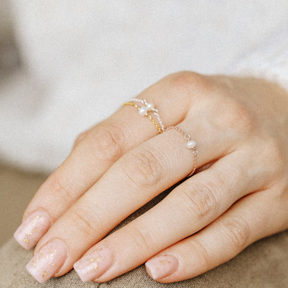 Pearl chain ring in silver and gold tones styled on fingers