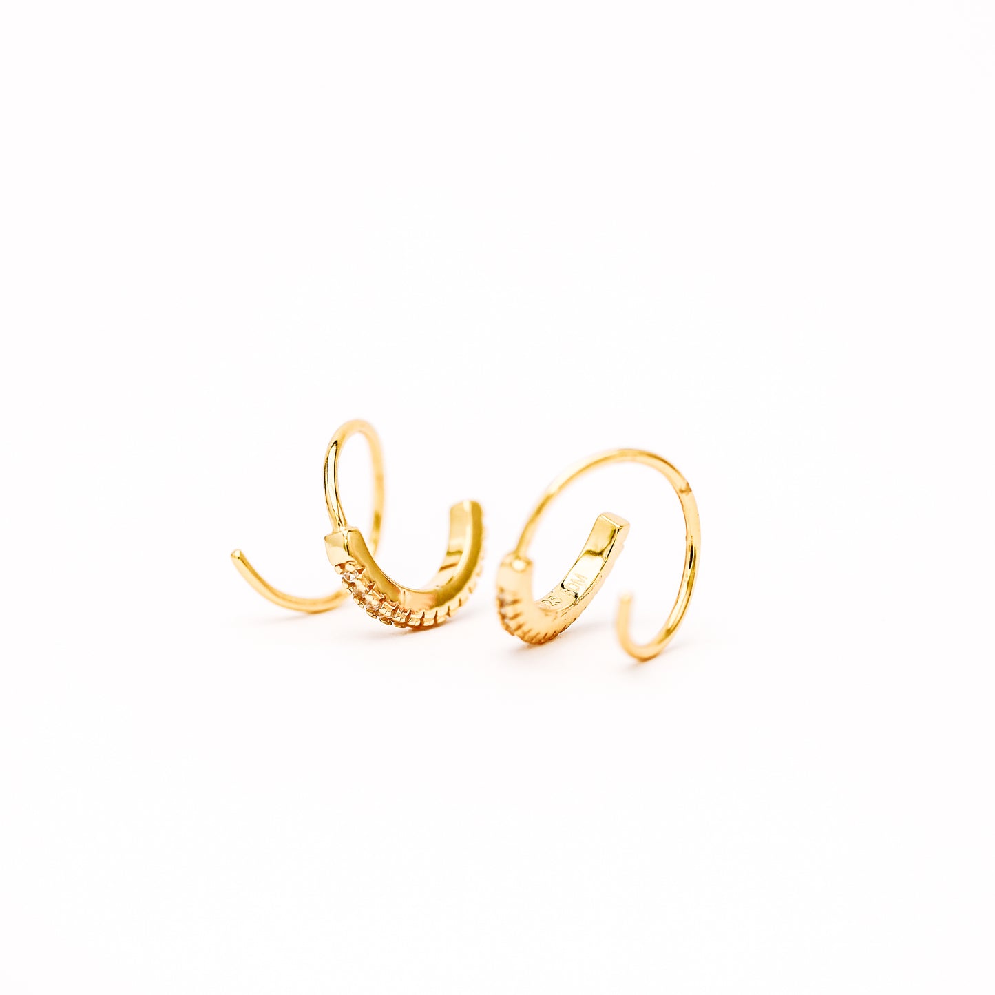 Lightweight gold twist hoop earring worn on ear