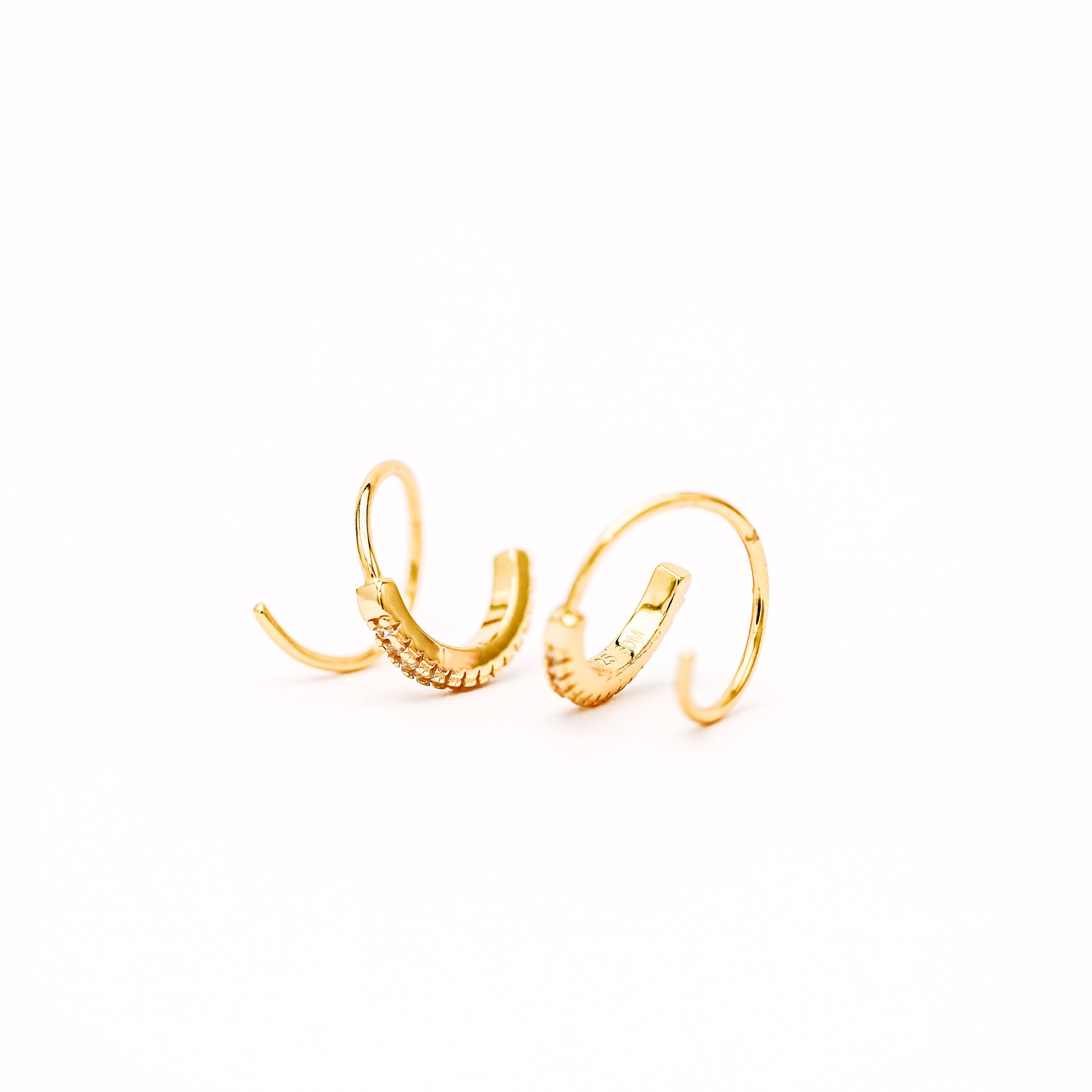 Lightweight gold twist hoop earring worn on ear