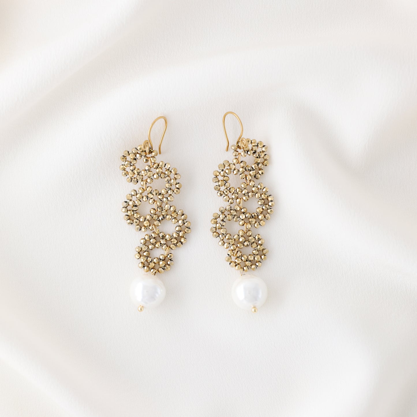Product photo of handmade gold crystal snake earrings with pearl drop